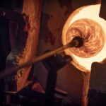 Image shows glass in a glassblowing oven.