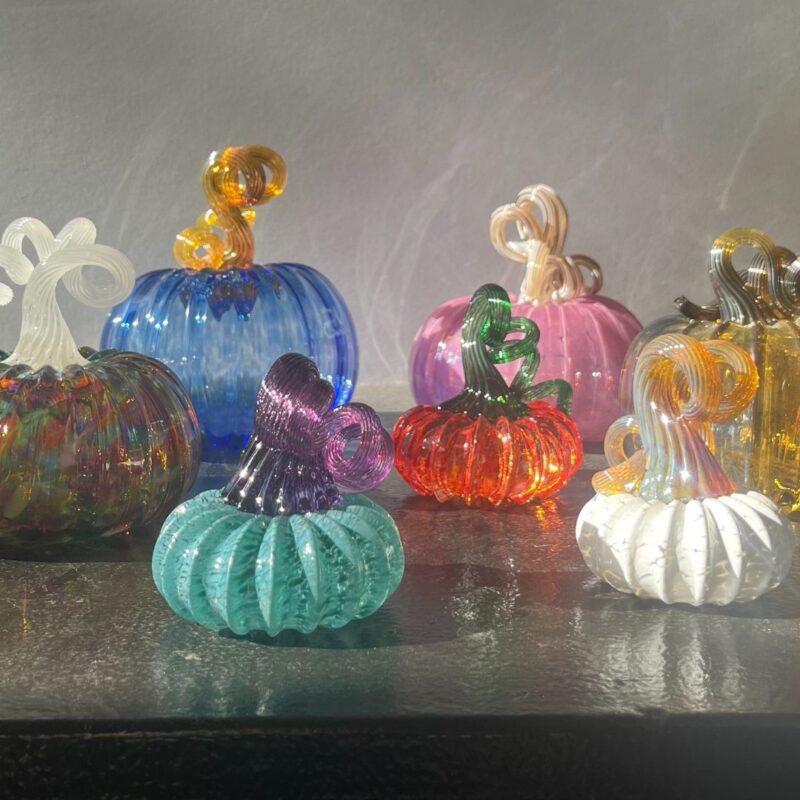 Image shows handcrafted glass pumpkins.