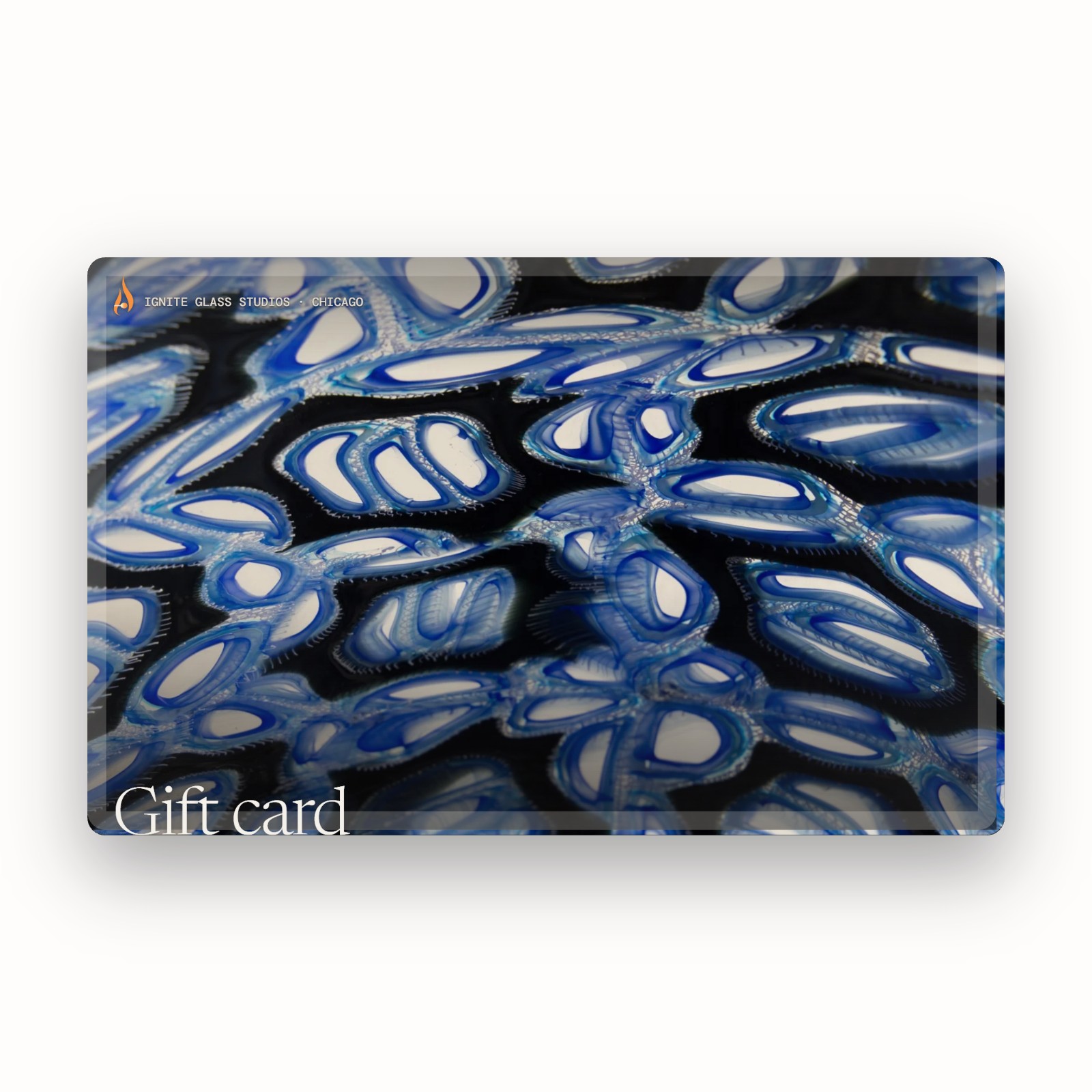 An Ignite Glass Studios gift card patterned with blue and white murrini glass, shown on white